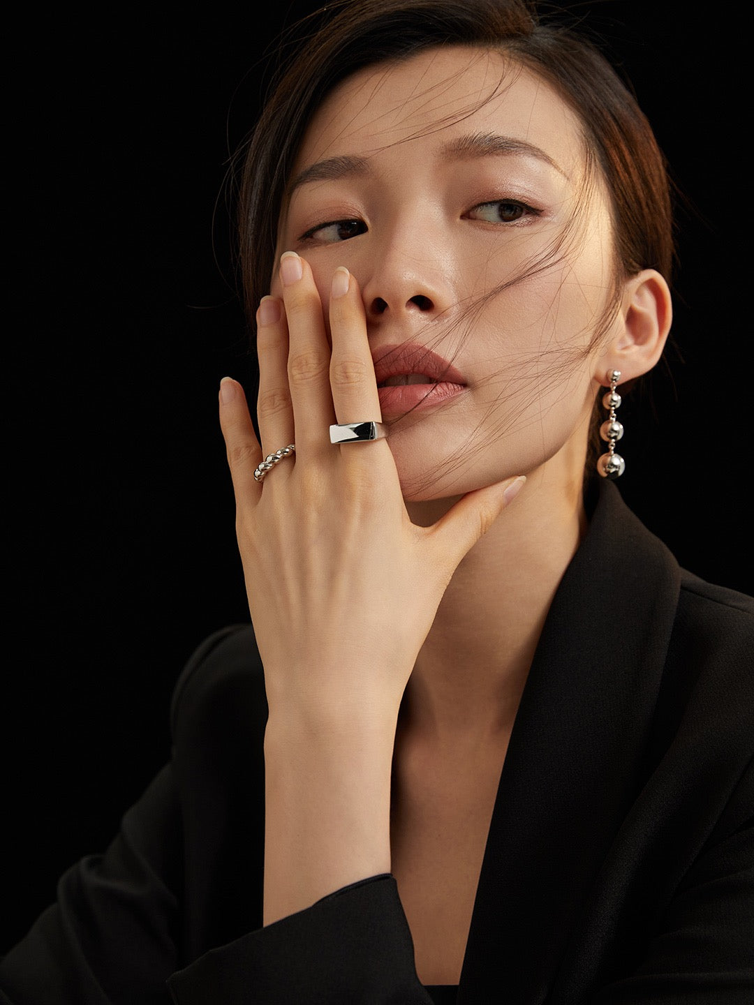 Model's hand gesturing to showcase the Amelia Sterling Silver Ring in a white gold color