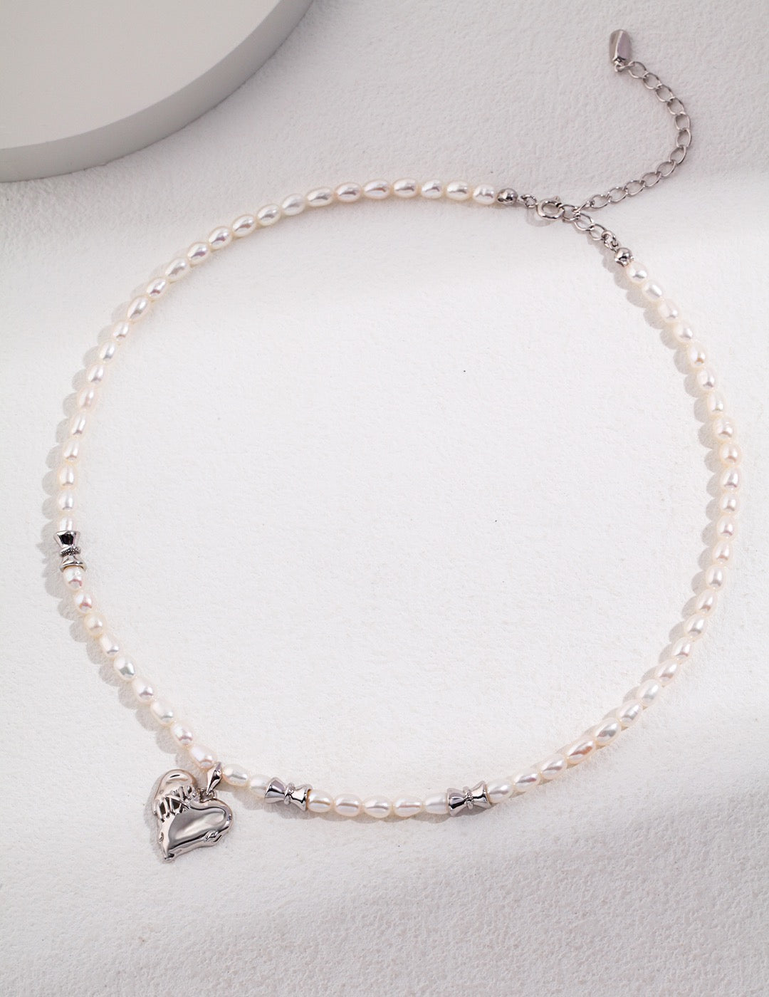 Platinum Silver and Vintage Gold color options for Delilah Love Stitch Collection necklace.