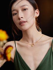 Model wearing Grace Sterling Silver Pearl Necklace in Retro Gold color