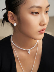 Model showcasing the asymmetric earrings, highlighting the earrings' artistic design