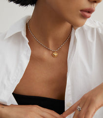 Model elegantly wearing Olivia Sterling Silver Heart Necklace, showcasing retro and luxurious style