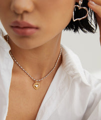 Model pairing Olivia Sterling Silver Heart Necklace with a chic outfit, emphasizing modern fashion aesthetics