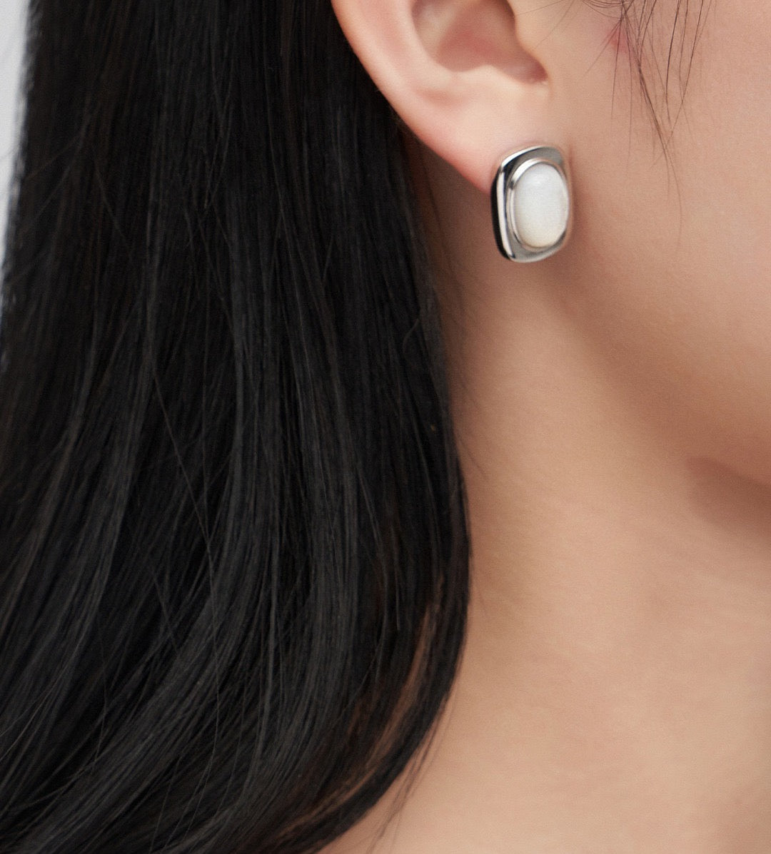 Model elegantly wearing Victoria Sterling Silver Cloudy Shell Earrings