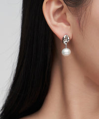 Model showcasing Anthea Sterling Silver Pearl Earrings, enhancing a luxurious look